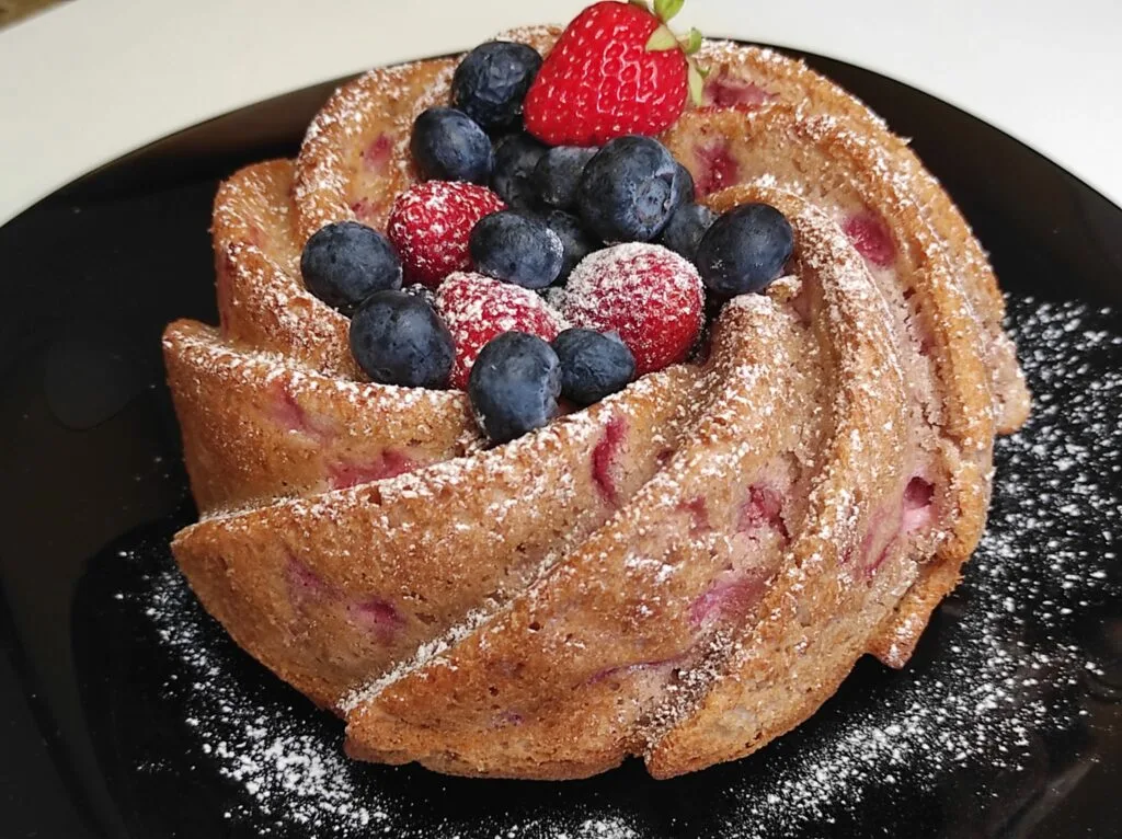 Bizcocho de fresa decorado con fresas y arandanos